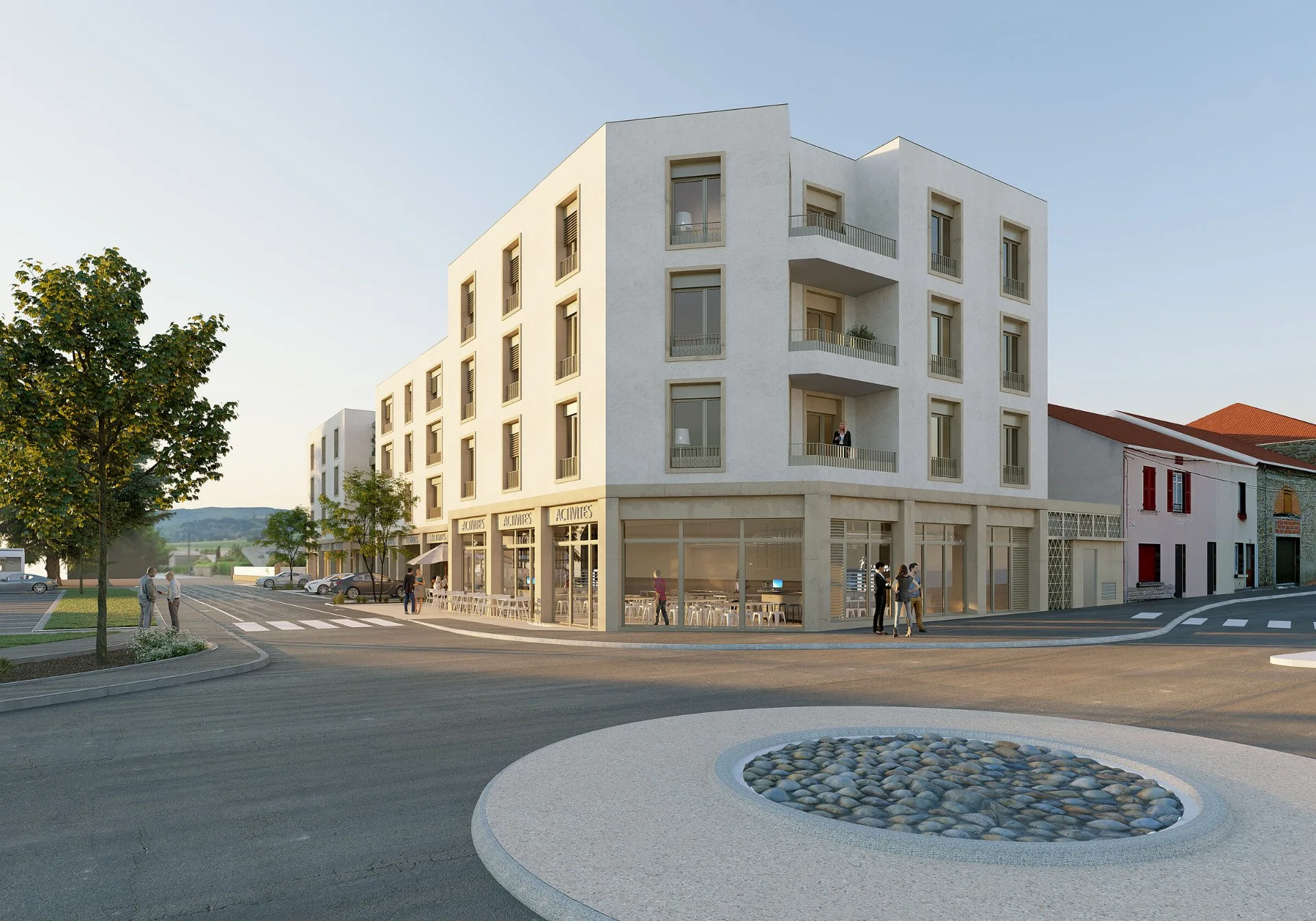 Vue d'angle sur l'entrée principale et les commerces au pied d'immeuble